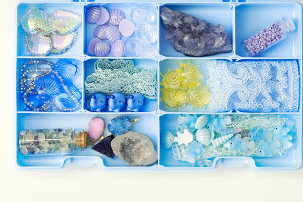 istock Container with shells, fish figures, crystals, stones, lace ribbons, artificial flowers and other collectibles 1301980243
