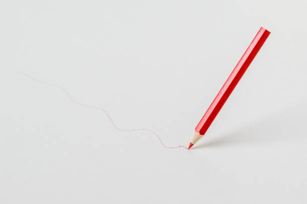istock Red pencil drawing a line on a white background. 1301982513