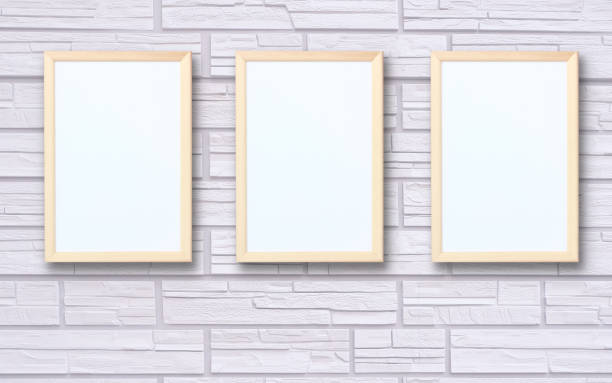 istock three empty wooden photo frames on the wall. 1301982671