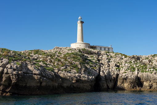 Santander, Spain - July 12, 2019: Mouro island lighthouse with blue sky in the background, North of Spain.