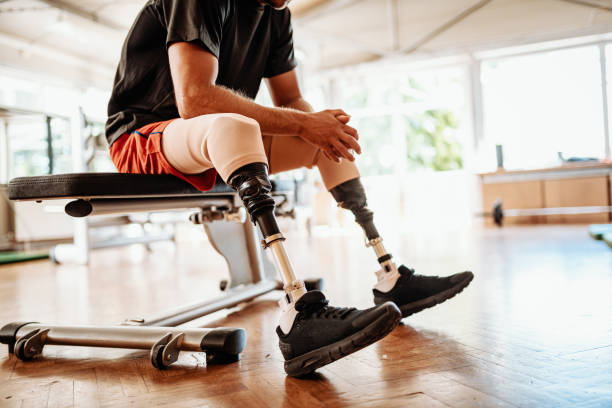 istock Differing ability athlete putting his prosthetic leg before exercising in the gym 1301984976