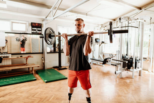 istock Differing ability athlete exercising in the gym and lifting weights 1301985024