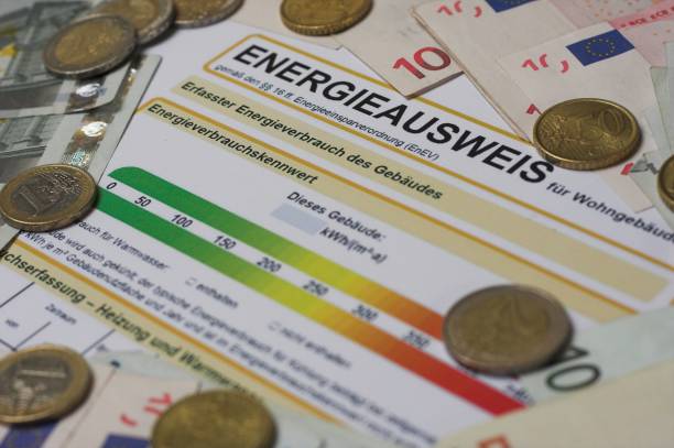 Form energy certificate Form energy certificate for a proof of energy efficiency in german language "Energieausweis" with euro bills and coins energieausweis stock pictures, royalty-free photos & images