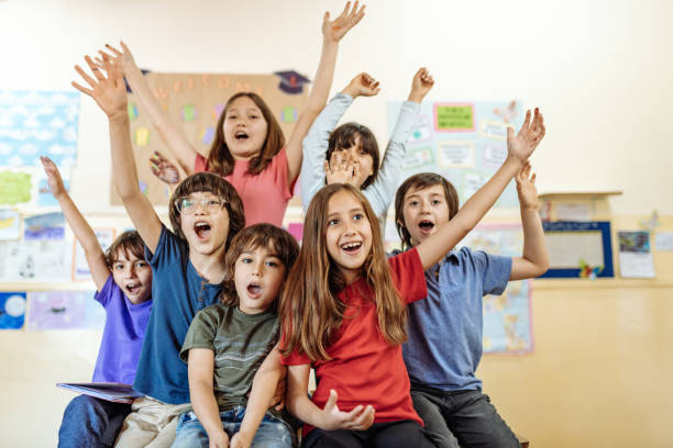 istock Hispanic kids in classroom at school in post-covid-19 world 1301989530