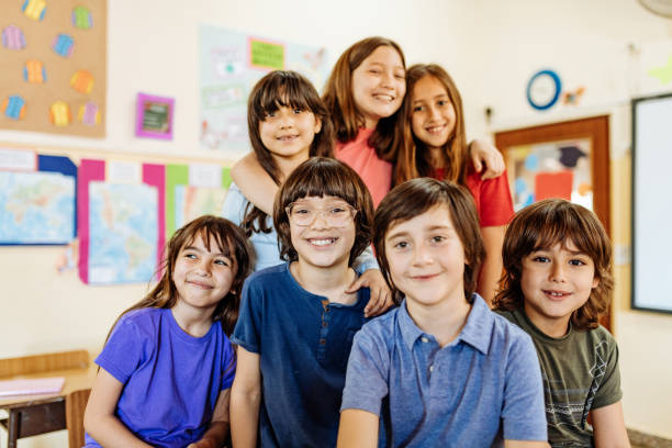 istock Hispanic kids in classroom at school in post-covid-19 world 1301989634