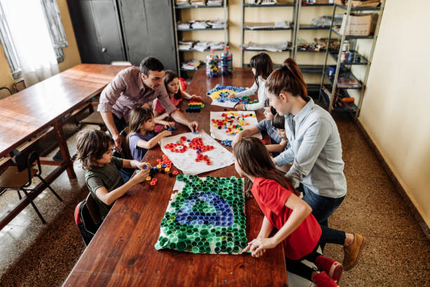 istock Primary school children making artwork with bottle caps 1301989702