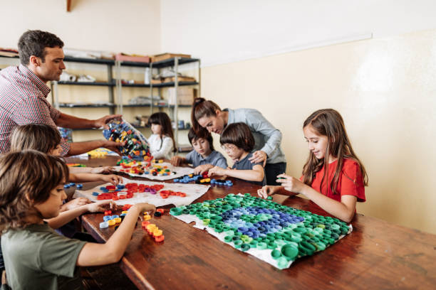 istock Primary school children making artwork out of recycled plastic 1301990392