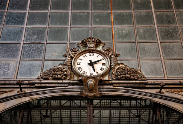 Old clock hanging on ancient market wall. stock photo