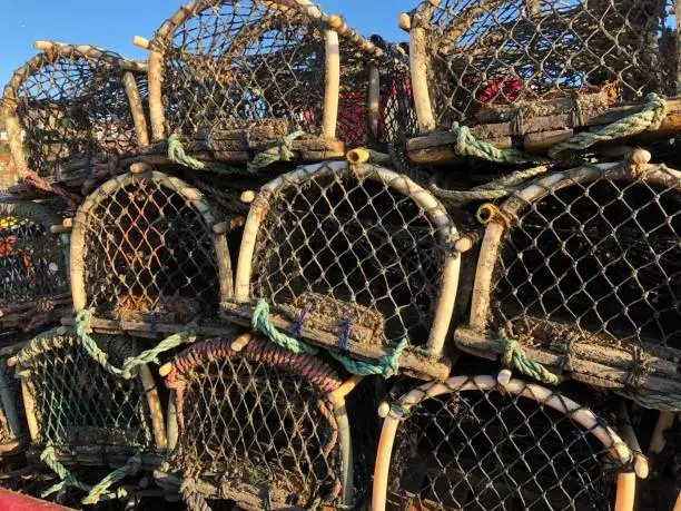 Lobster pots against a bright blue sky on harbour side at Whitby, East Ridings, Yorkshire Coastline, East Coast, North Sea, England, United Kingdom