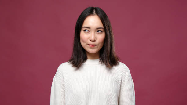 istock Young asian woman rejoices against marsala copyspace 1301995584