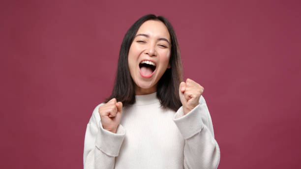 istock Young asian woman rejoices against marsala copyspace 1301995596