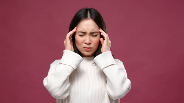 istock Young asian woman suffer headache against marsala copyspace 1301995699