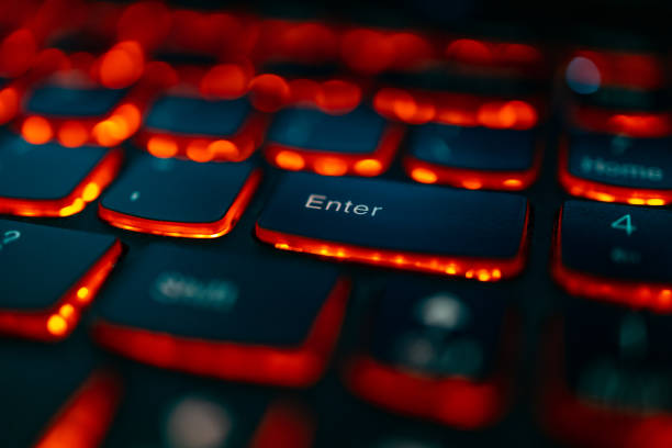 istock Old laptop with red highlighted keyboard with focus on Enter key 1301995803