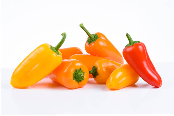 istock Orange, red and yellow peppers on white background 1301999499