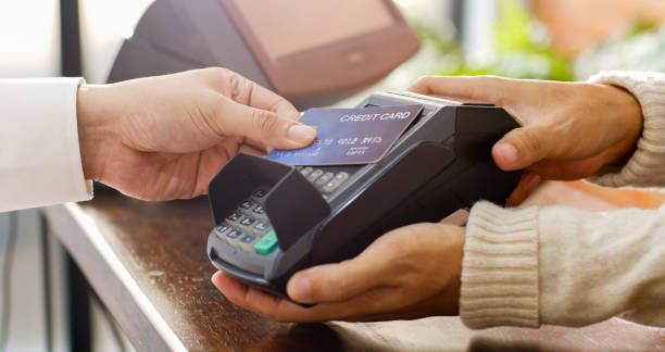 istock Customer using credit card for payment to owner at cafe restaurant, cashless technology and credit card payment concept 1302001699