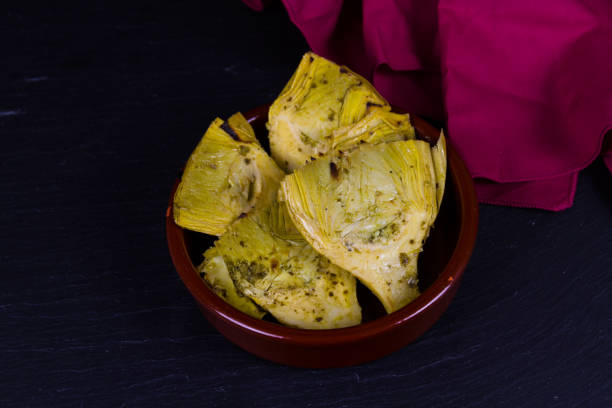 istock Artichoke Hearts in brown bowl red napkin, landscape, copyspace. 1302001820