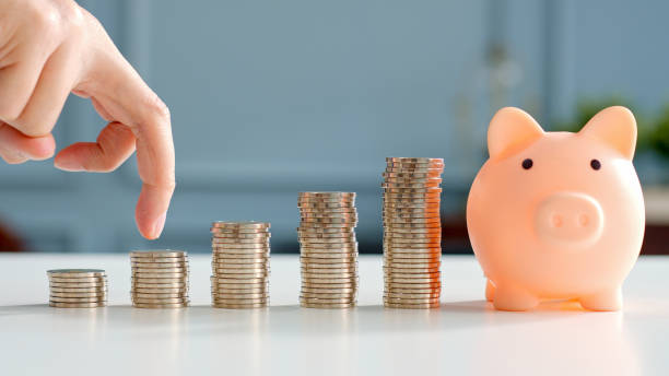 istock Closeup man hand finger step up on stacking coins, save money and growth concept 1302001975
