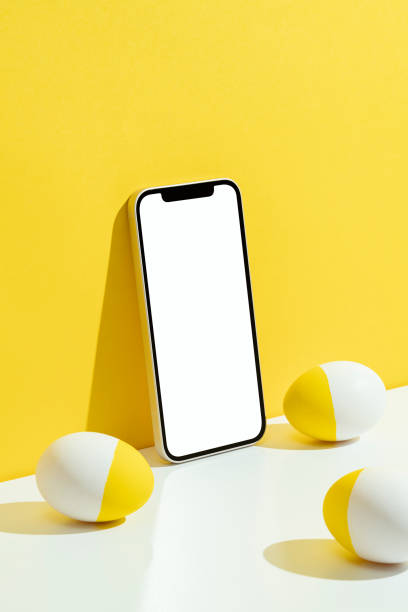 istock Easter eggs and phone mockup, template on yellow and white background 1302002927