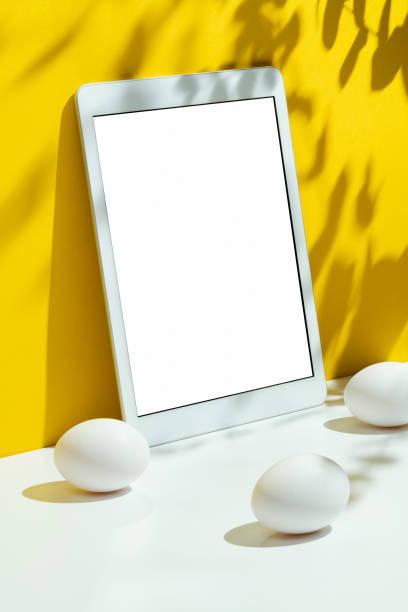 istock Eggs and digital tablet mockup, template on yellow and white background 1302003525