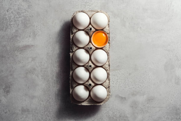 istock Box of eggs on gray background 1302003556