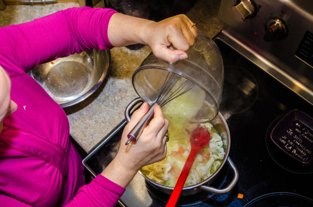istock Woman pouring flavored chicken broth in pan 1302004730