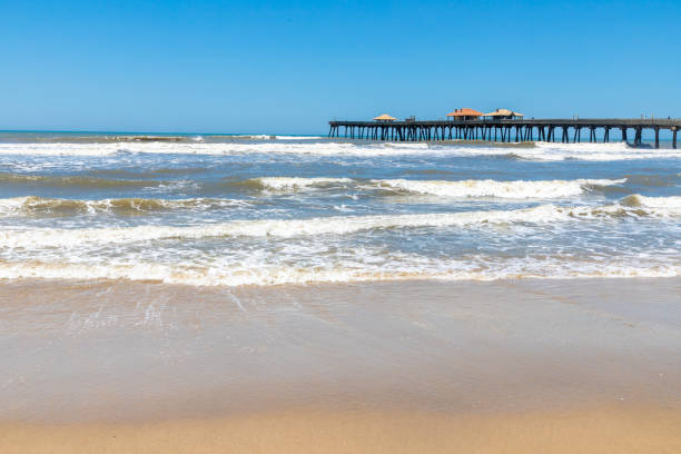 istock Fishermen pier, sand and waves 1302005875