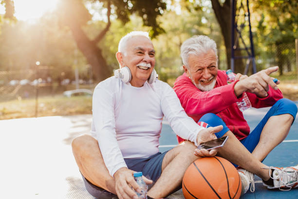 istock Two active senior men on basketball field taking a break from sport activity 1302006571