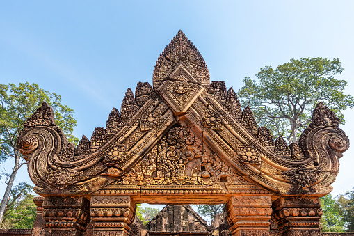 Banteay Srei, Cambodia - January 21, 2020: Banteay Srei is a 10th-century Cambodian temple dedicated to the Hindu god Shiva. It is built largely of red sandstone that can be carved like wood and millions of visitors admire the intricate reliefs carved in red colored sandstone.