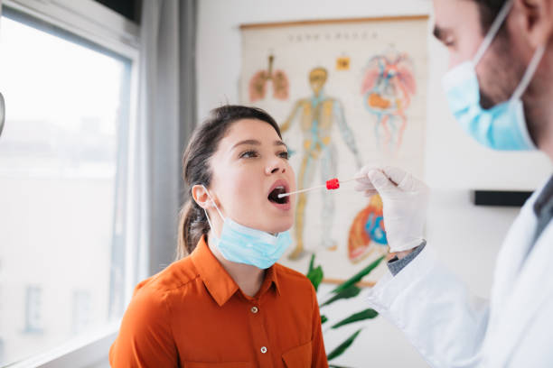 istock Doctor taking a swab from a patient 1302006829