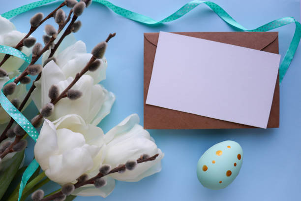 istock Easter greeting card mockup. spring flowers, willow twigs and Easter eggs 1302008673