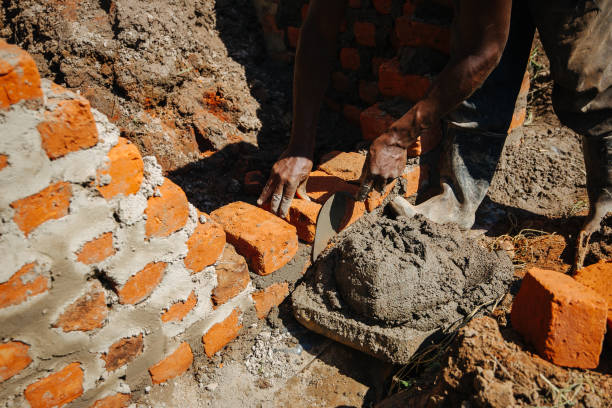 istock Man building a brick wall in Uganda, Africa 1302008889