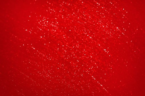 Red Glitter Christmas Background Pattern Bokeh Texture Valentine's day Chinese New Year Holiday Backdrop Toned Macro Photography for presentation, flyer, greeting card, poster, brochure, banner