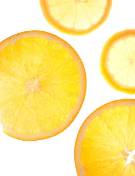 istock slice of orange and lemon on a white glowing background. 1302010623