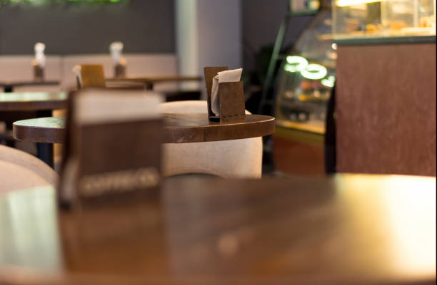 istock selective focus, holder for napkins on a wooden table in a cafe. blurred background. 1302011947