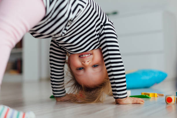 happy kid doing exercises on the floor - people joy relaxation concentration imagens e fotografias de stock
