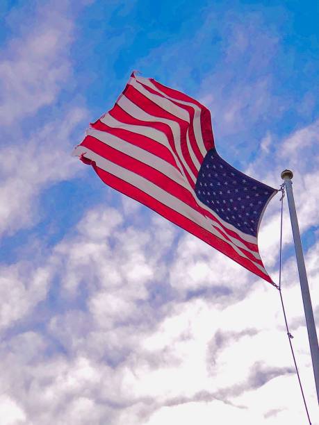 istock American Flag In Windy Sky 1302012923
