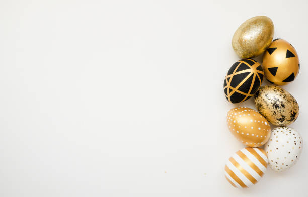 istock Easter golden decorated eggs isolated on white background. Minimal easter concept. Happy Easter card with copy space for text. Top view, flatlay 1302012925