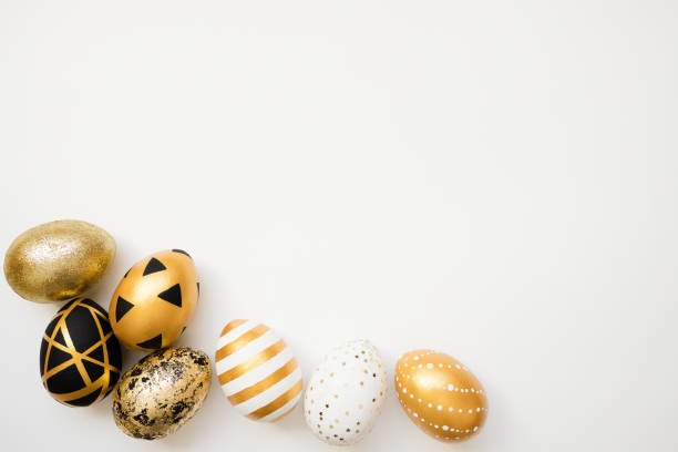 istock Frame of Easter golden decorated eggs isolated on white background. Minimal easter concept. Happy Easter card with copy space for text. Top view, flatlay 1302012933