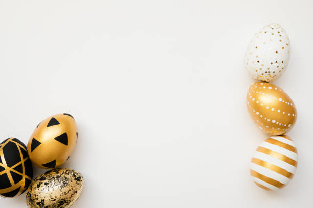 istock Easter golden decorated eggs isolated on white background. Minimal easter concept. Happy Easter card with copy space for text. Top view, flatlay 1302012945
