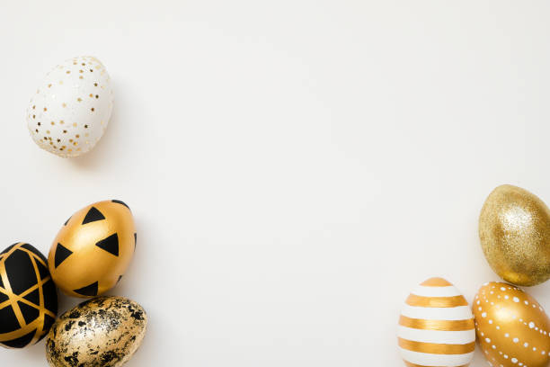 istock Easter golden decorated eggs isolated on white background. Minimal easter concept. Happy Easter card with copy space for text. Top view, flatlay 1302012962