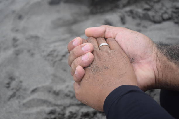 istock Holding hand and enjoying the sand. 1302016698