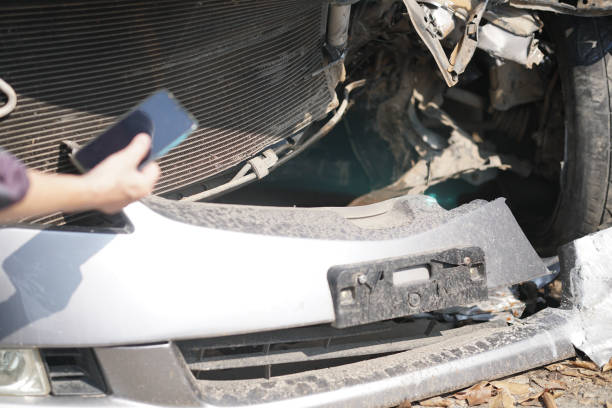istock hand take photo of crashed damaged broken car. automobile crash accident 1302017772