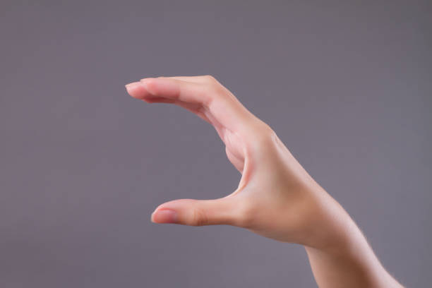 istock woman hand holding, catching, picking something 1302017942