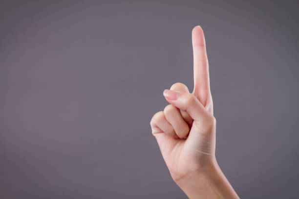 istock hand showing, pointing up 1 fingers, number one hand gesture 1302017951