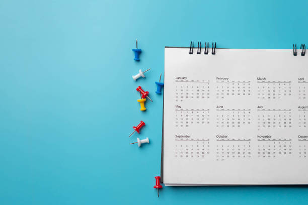 istock Calendar on solid blue background with copy space, business meeting schedule, travel planning or project milestone and reminder concept. 1302028660