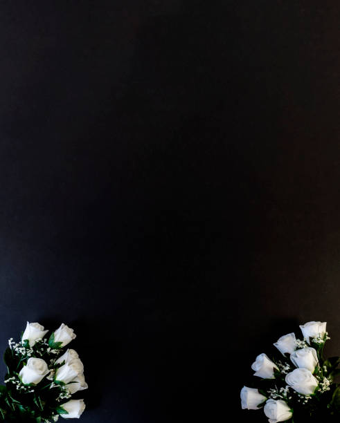 istock Flat Lay, postcard for death, funeral. White roses on a black background 1302029696