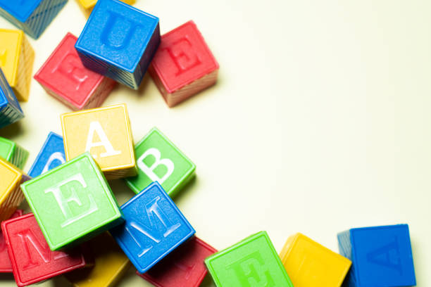 istock COLORFUL CUBE TOYS IN A YELLOW BACKGROUND 1302030434