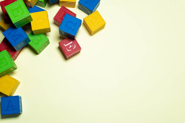 istock COLORFUL CUBE TOYS IN A YELLOW BACKGROUND 1302030486