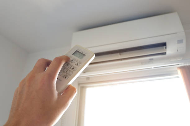 istock Man's hand using remote control open The air conditioner is cooled to 25 degrees Celsius in his bedroom. Health concepts and energy savings 1302031940