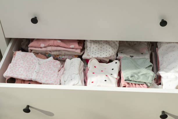 istock Cute newborn clothes in drawer 1302035527